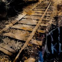 Thomas Dellert-Bergh | The Silent Railroad Tracks. 1980 Original Art. Hand-printed silkscreen on Murillo art paper with cloth Based on a photograph taken at Auschwitz Birkenau. 70 x 100 cm. Signed.